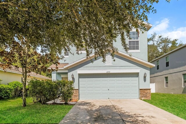 view of front of house with a garage and a front lawn