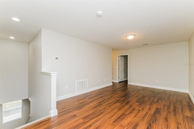 unfurnished room with dark hardwood / wood-style flooring