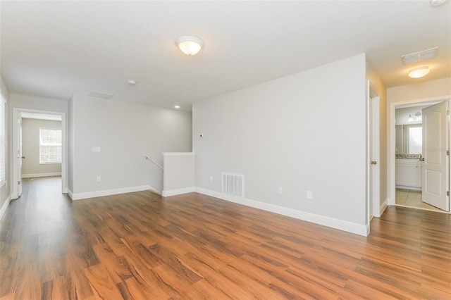 spare room with wood-type flooring