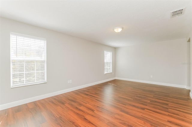 empty room with hardwood / wood-style floors