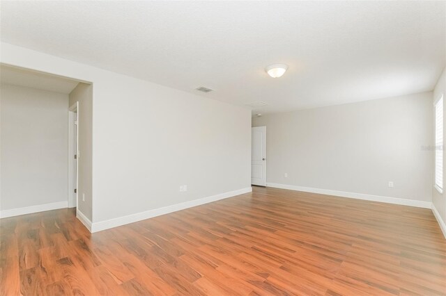 empty room with hardwood / wood-style floors