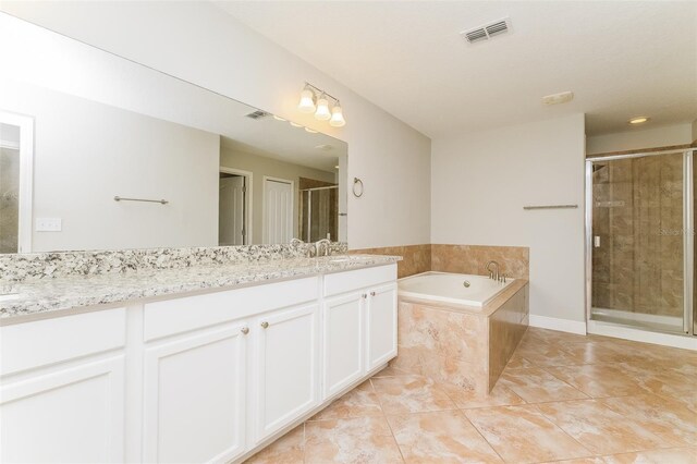 bathroom featuring vanity, tile patterned floors, and separate shower and tub