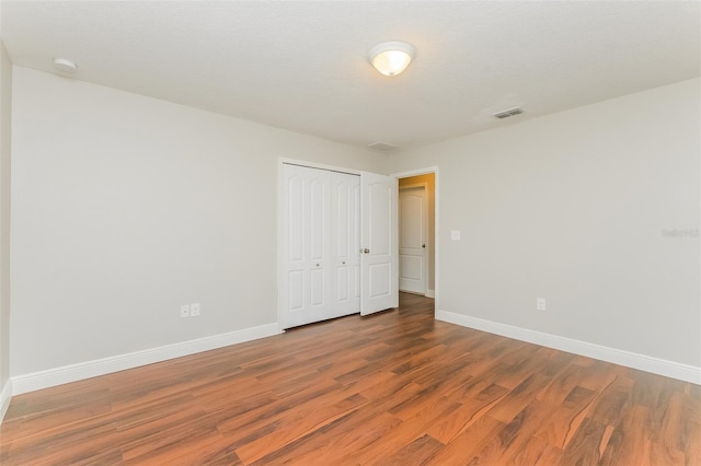 unfurnished room with wood-type flooring