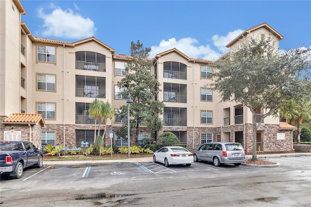 view of property featuring uncovered parking