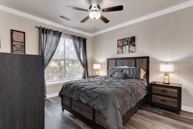 bedroom with ornamental molding, dark hardwood / wood-style floors, and ceiling fan