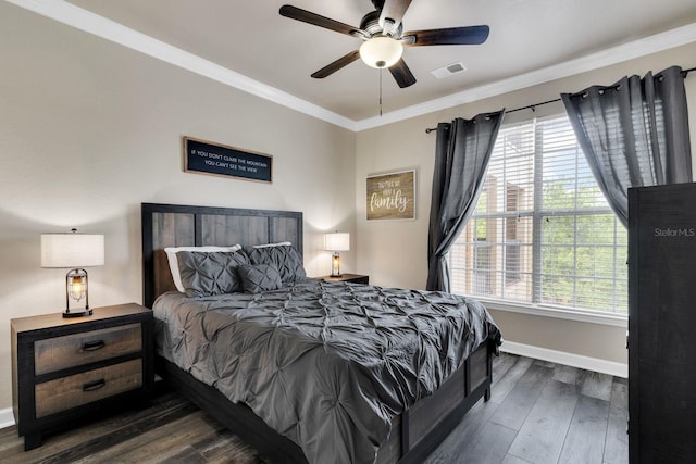 bedroom with crown molding, dark hardwood / wood-style flooring, and ceiling fan