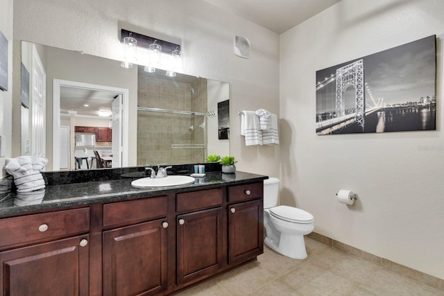 bathroom featuring vanity, toilet, and tile patterned flooring