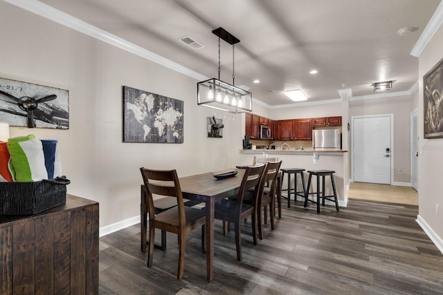 dining space with ornamental molding and hardwood / wood-style floors