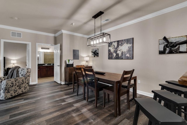 dining room with electric panel, ornamental molding, dark hardwood / wood-style flooring, and an inviting chandelier