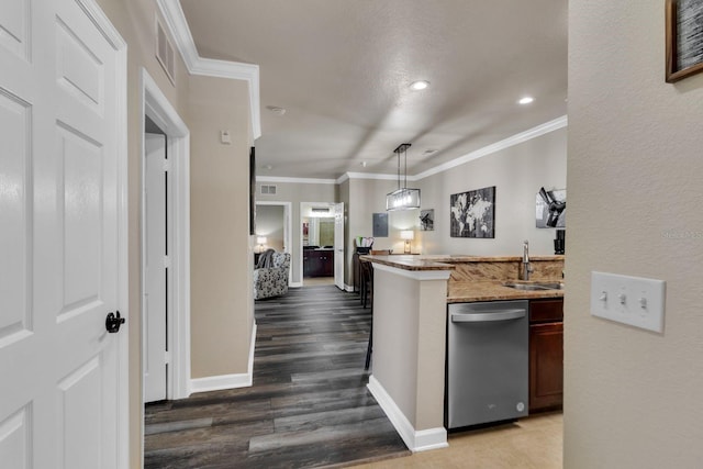 kitchen with pendant lighting, dishwasher, sink, ornamental molding, and hardwood / wood-style flooring