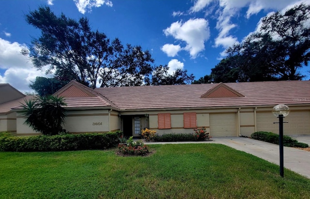 ranch-style home with a garage and a front yard