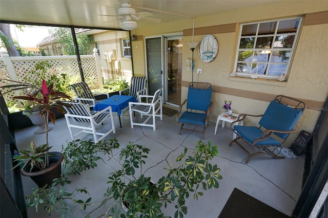 sunroom / solarium featuring ceiling fan