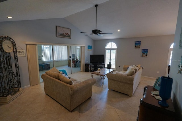 tiled living room with ceiling fan and high vaulted ceiling