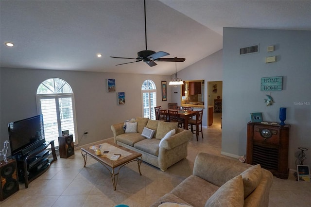 living room featuring plenty of natural light, light tile patterned floors, and ceiling fan with notable chandelier