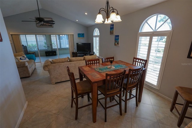 dining area with ceiling fan with notable chandelier, light tile patterned floors, and lofted ceiling