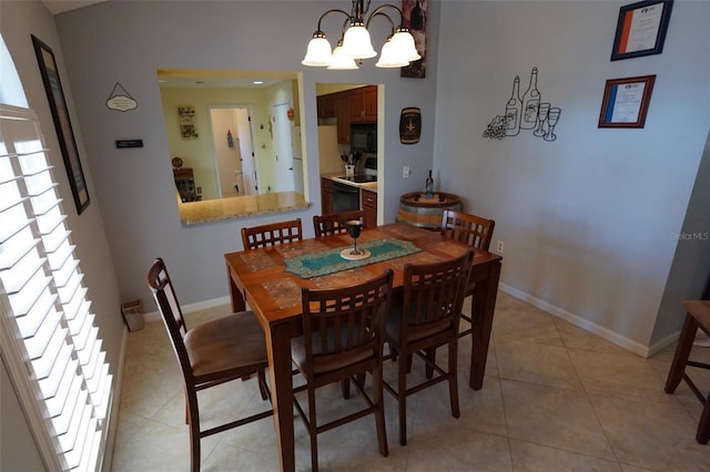 dining area with light tile patterned floors and a notable chandelier