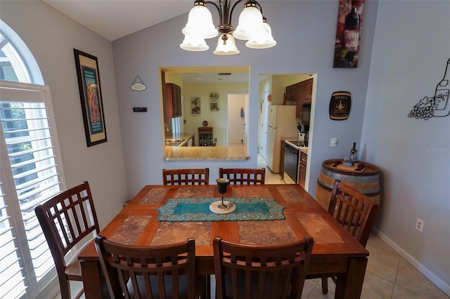 dining area featuring a chandelier, plenty of natural light, and light tile patterned flooring