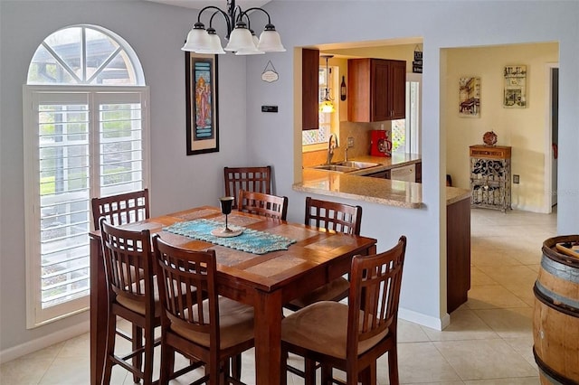 tiled dining space with sink, a chandelier, and plenty of natural light