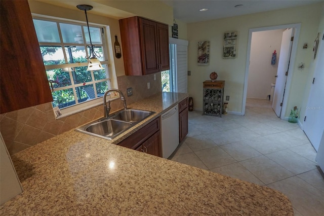 kitchen with sink, backsplash, white dishwasher, pendant lighting, and light tile patterned floors