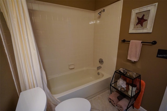 bathroom with tile patterned flooring, shower / tub combo, and toilet