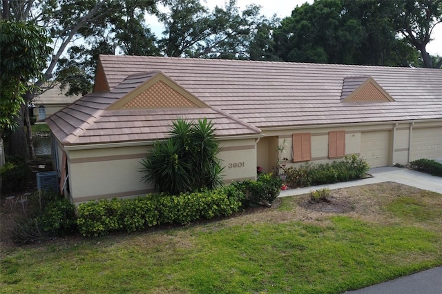 view of front of home with a garage and a front lawn