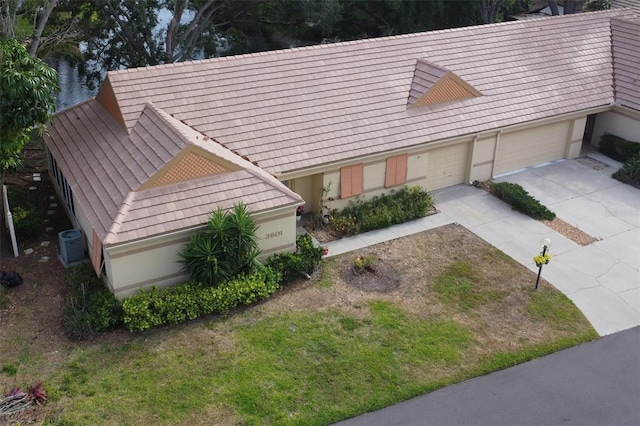 view of front of property featuring a garage and central air condition unit