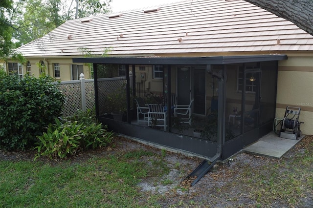 rear view of property with a sunroom