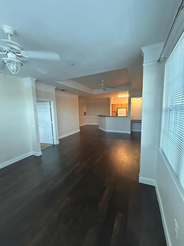 unfurnished living room with ceiling fan with notable chandelier and dark hardwood / wood-style floors