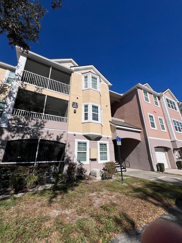 6413 Astor Village Ave Unit 303, Orlando, FL 32835 - view of building exterior with a garage