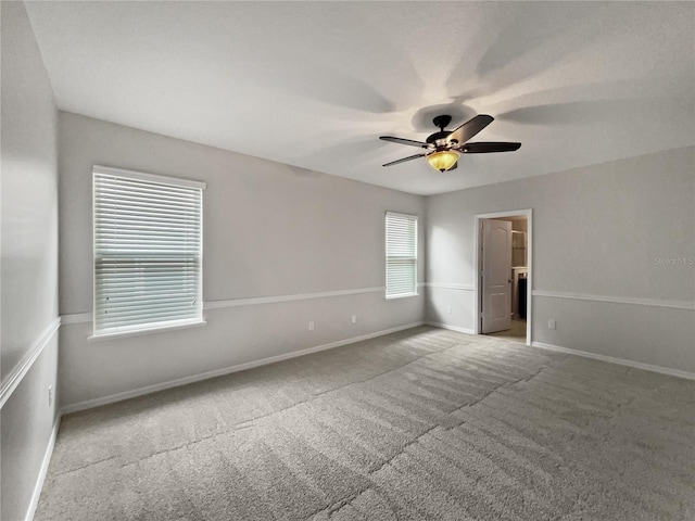 spare room featuring carpet flooring and ceiling fan