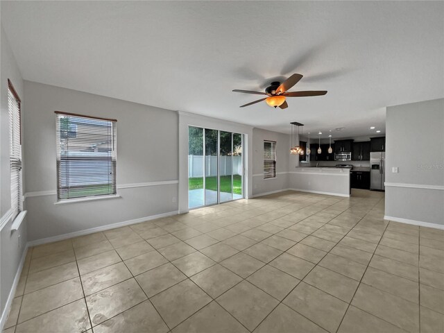 unfurnished living room with ceiling fan and light tile patterned floors