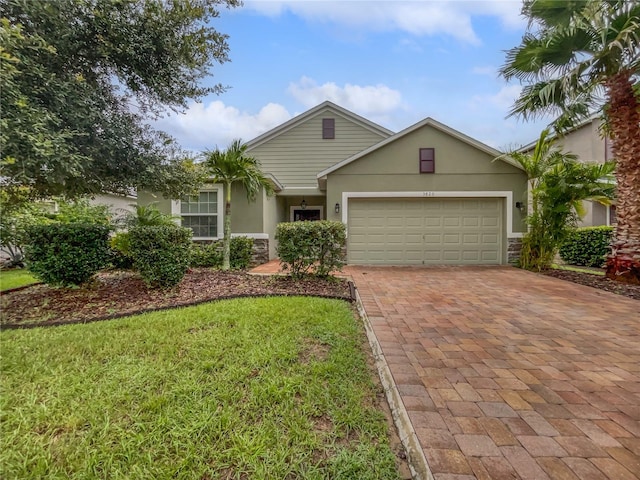 view of front of property featuring a front yard and a garage