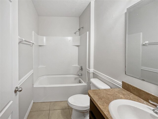 full bathroom with tile patterned floors, washtub / shower combination, vanity, and toilet