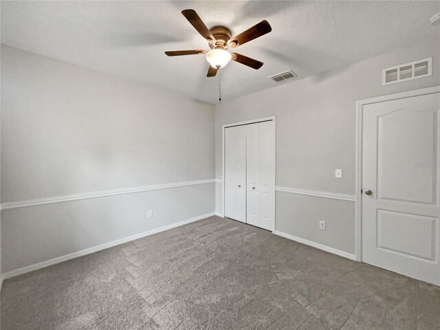 unfurnished bedroom with ceiling fan, a closet, and carpet