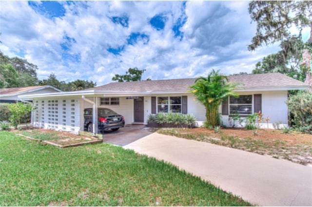 ranch-style home with a carport and a front lawn