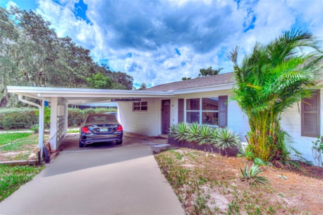 ranch-style house featuring a carport