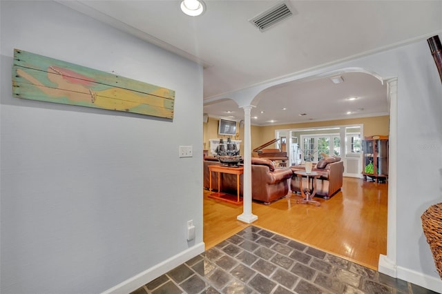 279 Rippling Ln, Winter Park, FL 32789 - hallway featuring ornate columns, arched walkways, baseboards, recessed lighting, and crown molding