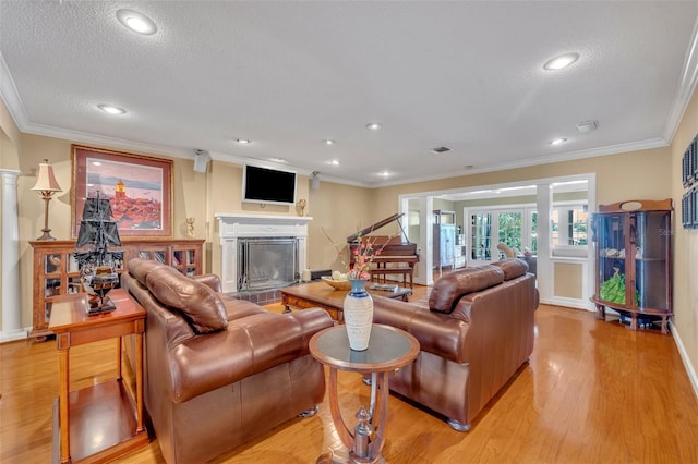 279 Rippling Ln, Winter Park, FL 32789 - living area with a textured ceiling, a glass covered fireplace, light wood finished floors, crown molding, and recessed lighting