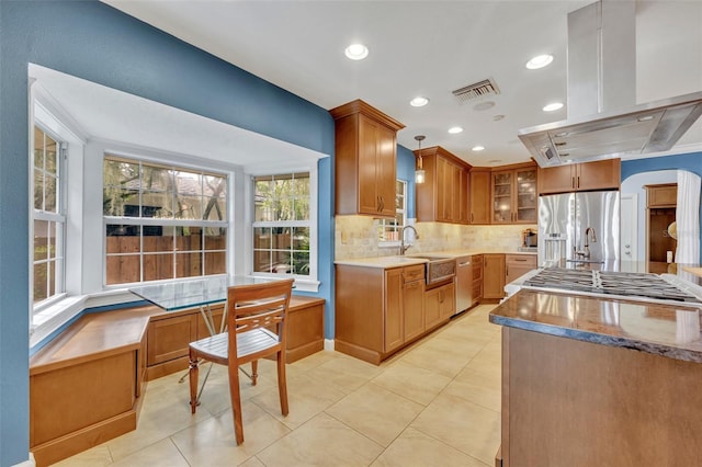 279 Rippling Ln, Winter Park, FL 32789 - kitchen featuring appliances with stainless steel finishes, a sink, island range hood, tasteful backsplash, and healthy amount of natural light