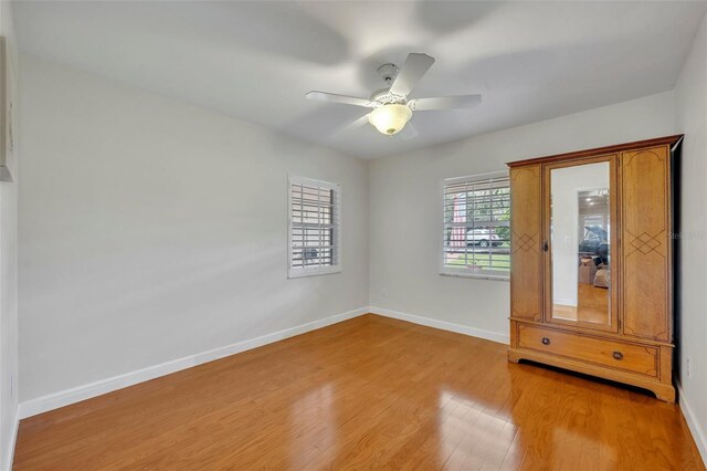 unfurnished bedroom with ceiling fan and light hardwood / wood-style floors