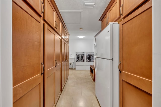 279 Rippling Ln, Winter Park, FL 32789 - laundry room featuring separate washer and dryer, light tile patterned floors, and a textured ceiling