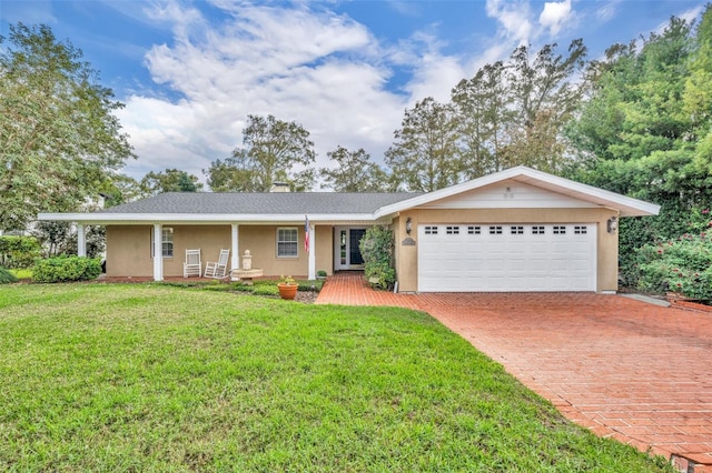 ranch-style house with a front yard, a porch, and a garage