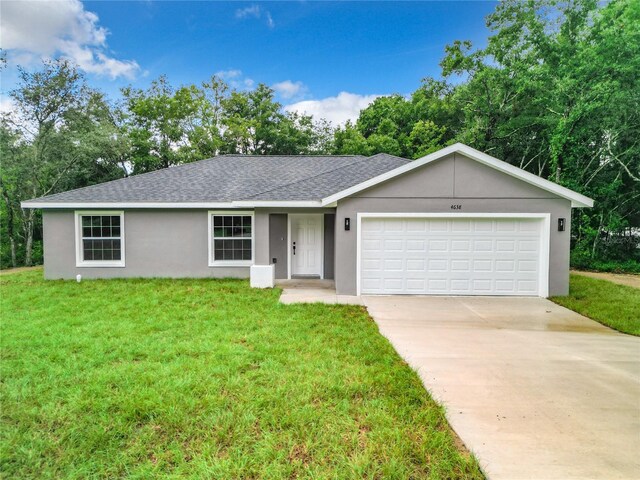 ranch-style house with a front lawn and a garage