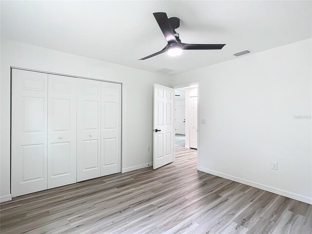 unfurnished bedroom featuring a closet, ceiling fan, and light hardwood / wood-style floors