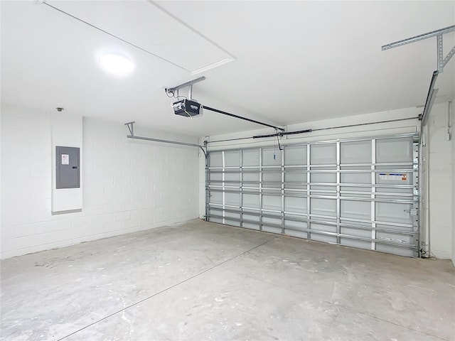 garage with a garage door opener and electric panel