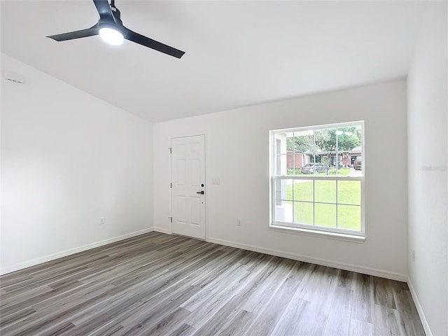 spare room with ceiling fan and light wood-type flooring