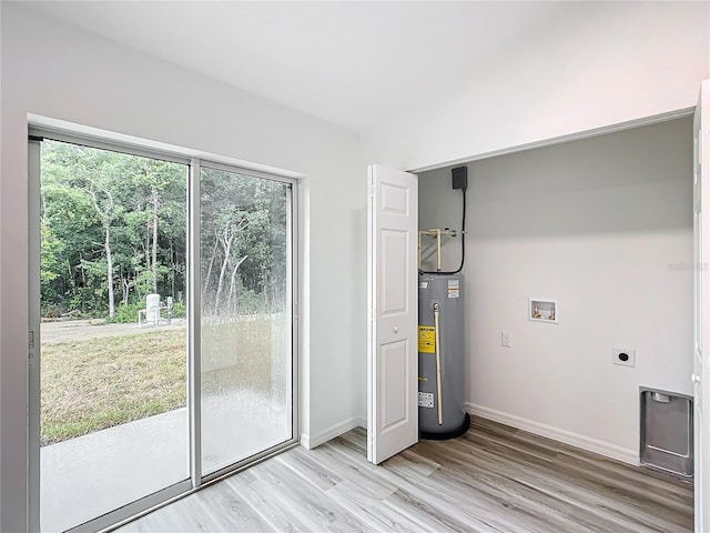 laundry area with water heater, light hardwood / wood-style floors, electric dryer hookup, and washer hookup