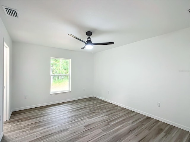 empty room with light wood-type flooring and ceiling fan