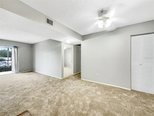 interior space with a textured ceiling and ceiling fan