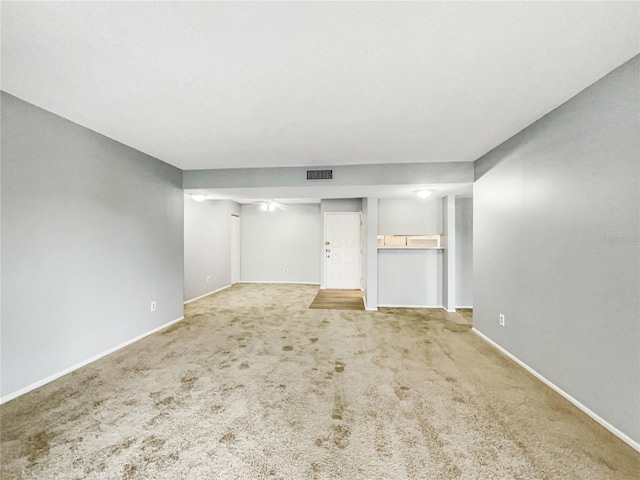 unfurnished living room featuring light carpet